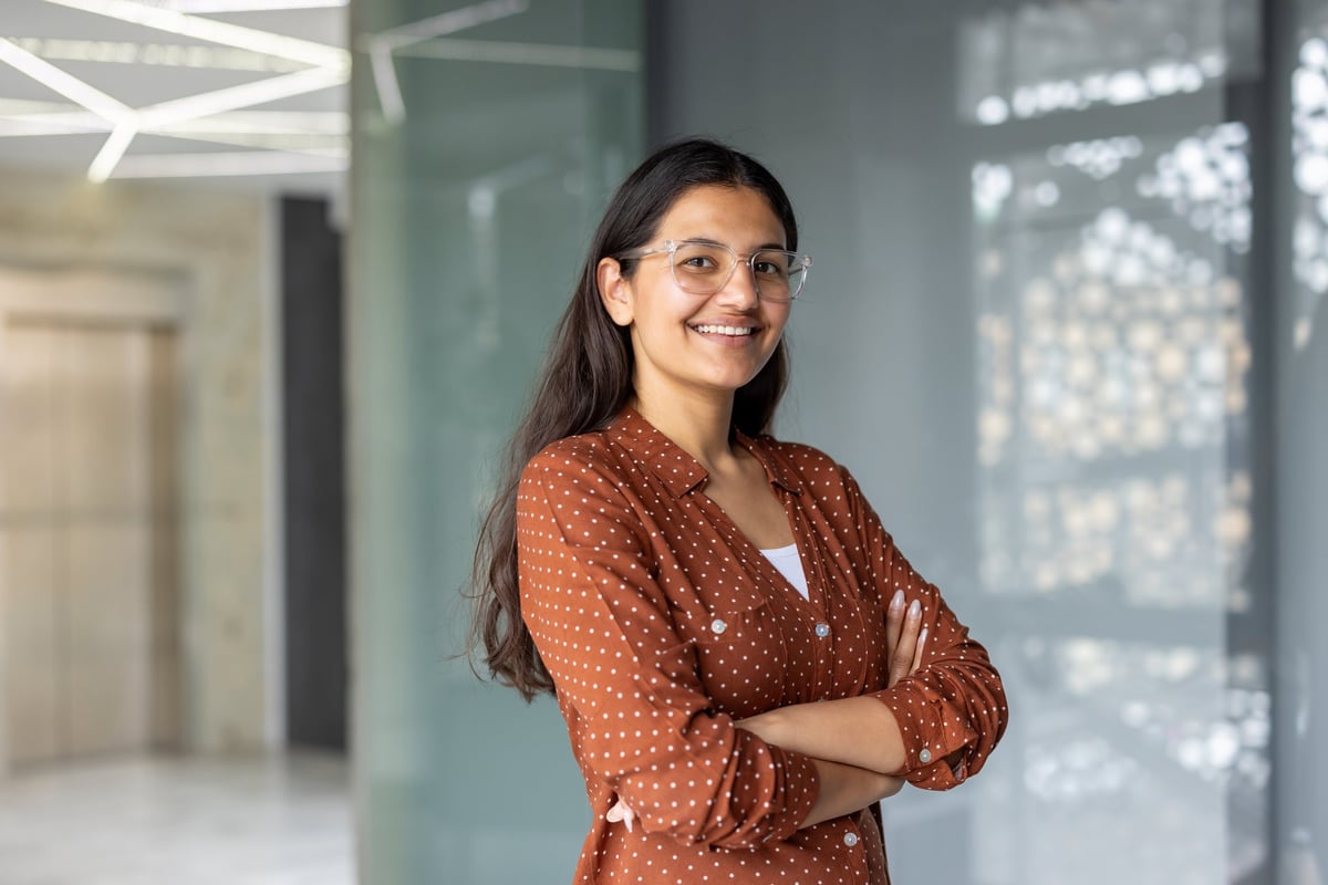 Indian woman in casual polka dot shirt with confident smile